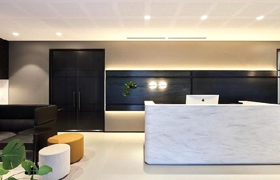 Reception desk with dark wall panels