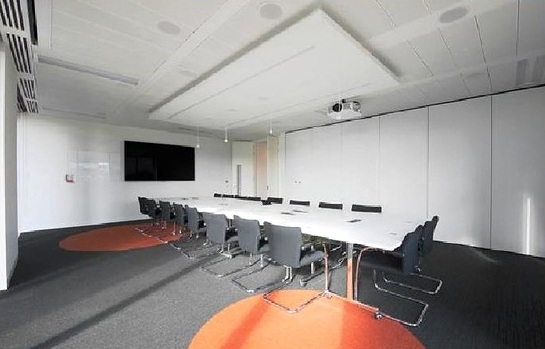 Meeting room with white table and feature carpet