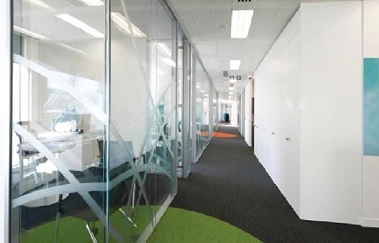 Glazed office corridor with patterned partitions